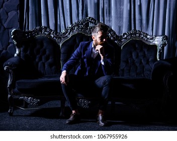 Luxury Life, Fashion, Wealth, Furniture, Elegance, Concept. Bearded Man With Sad Face In Classic Interior. Millionaire In Elegant Suit Sits On Luxurious Sofa. Brutal Man Or Advocate With Long Beard.