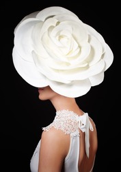 Luxury Lifestyle, Vogue And Style Concept-portrait Of Stylish Young Lady With Big White Rose On The Head, Isolated On Black Background, Fashionable Model Wearing Glamorous Floral Hat.