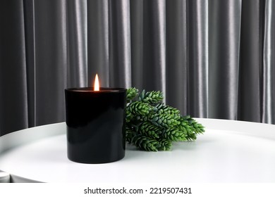 luxury lighting black glass aromatic scented candle is on white steel table with green plant to creat relax ambient in the bedroom with background of nice bedroom and grey curtain on Valentine day - Powered by Shutterstock