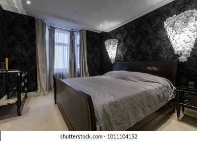 Luxury Master Bedroom In Dark Colours With Black Wallpaper And  Carpet Flooring And Stylish Furniture And Light