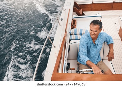 Luxury, mature man and boat in ocean for retirement, wealth and investment for travel. Leisure, happiness and male sailor on yacht for sailing, adventure and transportation on lake with high angle - Powered by Shutterstock