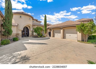 A luxury Mediterranean home with a circular driveway