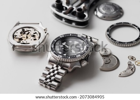 Luxury men wrist watch with watch parts over white background. Repairing wrist watch concept.