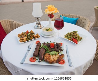 Luxury mixed grill meat meal in outdoor table setting at oriental restaurant