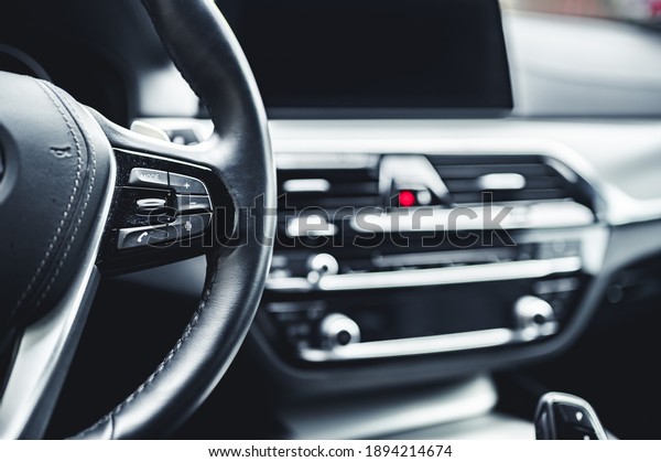 Luxury modern car interior. Automatic gearbox\
lever; Automatic transmission gearshift stick. Steering wheel,\
shift lever and\
dashboard.