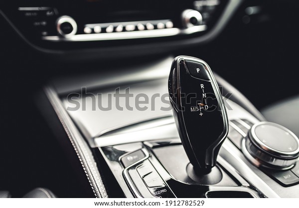 Luxury modern car interior. Automatic gearbox\
lever; Automatic transmission gearshift stick. Steering wheel,\
shift lever and\
dashboard.