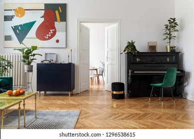 Luxury and modern home interior with design furniture, armchair, tables, pouf and accessroies. A lot of big plants on the piano. White walls with abstract image. Stylish decor of living room.