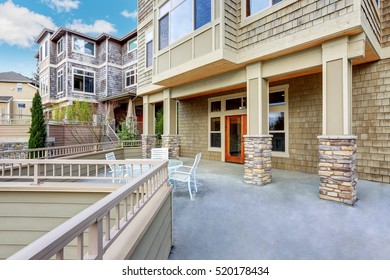 Luxury Multi Level Home Exterior. Spacious Terrace With Stone Columns And Nice View . Northwest, USA