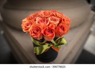 Luxury orange roses filled in an elegant box with ribbon