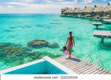 Luxury Overwater Bungalows Tahiti Resort Woman Going Snorkeling From Private Hotel Room On Bora Bora Island, French Polynesia. Travel Vacation Recreational Activity Watersport Fun Leisure.