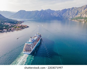 Luxury passenger liner in the bay of Kotor with travel returning after the Covid 19 pandemic Portrait of a disgruntled girl sitting at a cafe table - Shutterstock ID 2203071997