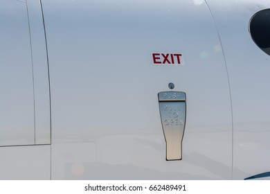 Luxury Private Jet Airplane Door. Exit Sign Over The Door Handle.