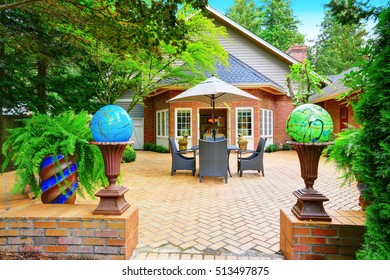 Luxury Red Brick House Exterior. Paved Patio With Globe Lights. Northwest, USA