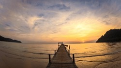 Luxury Resort Bridge Pier With Soft Led Lights Under Colorful Sky Clouds. Sunset In Beach Wooden Jetty. Sunset Lake Pier Landscape View. The Wooden Pier At Sunset.