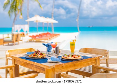 Luxury resort hotel poolside, outdoor restaurant on the beach, ocean and sky, tropical island cafe, tables, food. Summer vacation or holiday, family travel. Palm trees, infinity pool, cocktails, relax