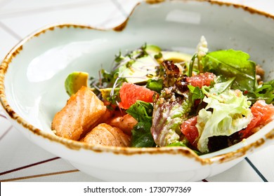 Luxury Restaurant Side Dish Top View. Salad With Salmon And Avocado. Fish And Vegetable Mix. Entree Addition. Delicious Meal Course In Deep Craft Plate. Fancy Gourmet Food Overhead Shot