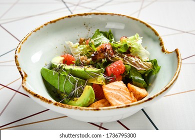 Luxury Restaurant Side Dish Top View. Salad With Salmon And Avocado. Fish And Vegetable Mix. Entree Addition. Delicious Meal Course In Deep Craft Plate. Fancy Gourmet Food Overhead Shot