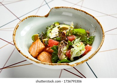 Luxury Restaurant Side Dish Top View. Salad With Salmon And Avocado. Fish And Vegetable Mix. Entree Addition. Delicious Meal Course In Deep Craft Plate. Fancy Gourmet Food Overhead Shot