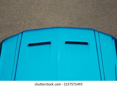 Luxury retro sports car in blue. Top view of the hood of a sports car on a gray asphalt background. The hood of a retro car with air intakes. Vintage equipment.