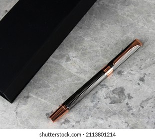Luxury Roller Pen Ball Pen gift in box, copper and grey self textured VIP gifts. Black gift box featuring business gift. Promotional gifts and premiums for corporate companies. Office give aways. - Shutterstock ID 2113801214