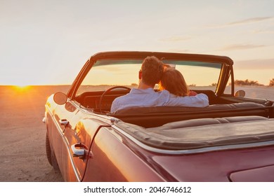 luxury, romantic couple in vintage classic cabriolet car at sunset - Powered by Shutterstock