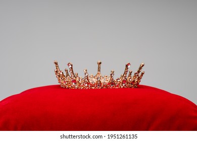 Luxury Royal Crown On Red Velvet Cushion Isolated On Grey