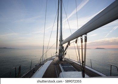 Luxury Sail Boat Sailing In Sea During Sunset