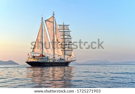Luxury sailing yacht at sunset in the sea