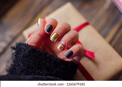 Luxury short manicure dark wooden background  Black matt nails design and golden color  