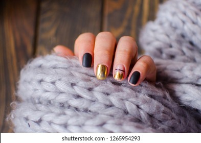 Luxury short manicure dark wooden background  Black matt nails design and golden color  