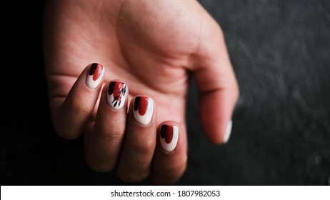 Luxury short manicure dark wooden background  cozy autumn nails  Red   black color nails 