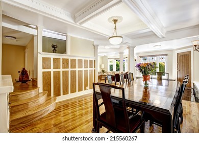 Luxury Spacious Dining Room With Hardwood Floor, Wood Wall Trim And Coffered Ceiling. Room In Brown And White Tones