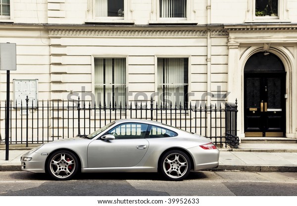 Luxury sport car in\
front of a house facade