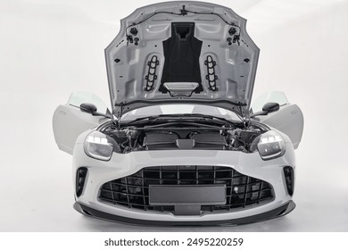 Luxury sport car with open engine in a white studio close up - Powered by Shutterstock