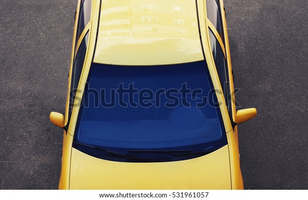 Luxury sports car. Top view\
automobile, roof, windshield and hood background on\
road.
