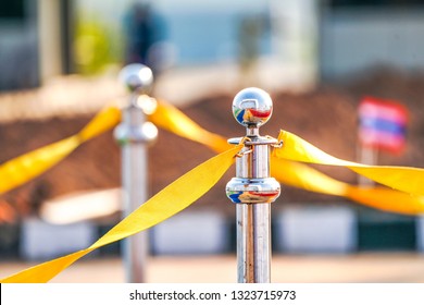 Luxury Stainless Barricade With Yellow Rope Ribbon On The Road In Marathon Event At The Finish Point. 