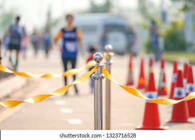 Luxury Stainless Barricade With Yellow Rope Ribbon On The Road In Marathon Event At The Finish Point. 