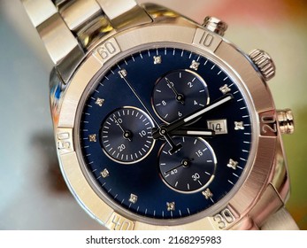 Luxury stainless steel watch with chronograph, dark blue dial and metal bracelet close-up. Macrophotography of watch details - Shutterstock ID 2168295983