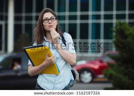 Luxury student girl outdoor portrait near university, cars on background