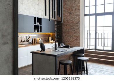 Luxury Studio Apartment With A Free Layout In A Loft Style In Dark Colors. Stylish Modern Kitchen Area With An Island, Cozy Bedroom Area With Fireplace And Personal Gym