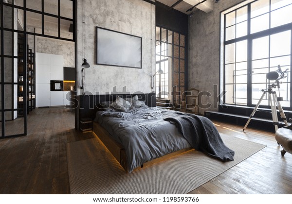 luxury studio apartment with a\
free layout in a loft style in dark colors. Stylish modern kitchen\
area with an island, cozy bedroom area with fireplace and personal\
gym