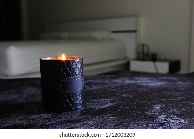 The Luxury Stylish Design Aroma Scented Glass Candle Is Lighting In The White Bedroom On The Dark Marble Texture Table