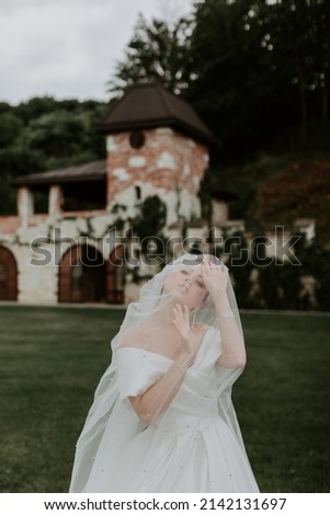 luxury stylish young bride on the background spring sunny green forest
