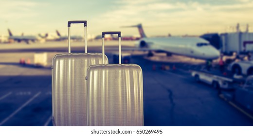 Luxury suitcases in airport terminal waiting area, passenger airplane in background.
Summer traveling vacation concept. Focus on suitcases. - Shutterstock ID 650269495