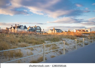 Luxury Summer Homes Along The Coastline And Board Walk In Spring Lake, New Jersey; Against Pastel Colored Sunset Skies.