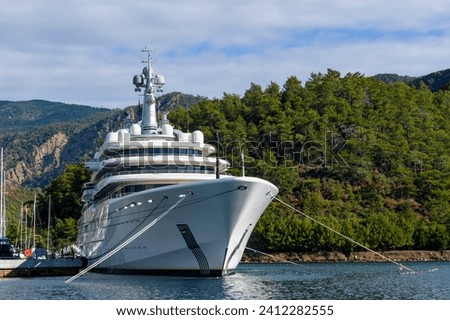 Luxury super yacht moored alongside in marina. Forward view. Motor yacht. Yachting concept. 