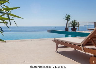 Luxury swimming pool and blue water at the resort with beautiful sea view. - Powered by Shutterstock