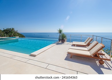 Luxury swimming pool and blue water at the resort with beautiful sea view - Powered by Shutterstock