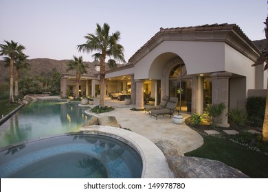 Luxury swimming pool and house exterior at dusk