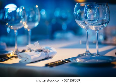 Luxury Table Setting Focus On The Glass Blue Background. 
